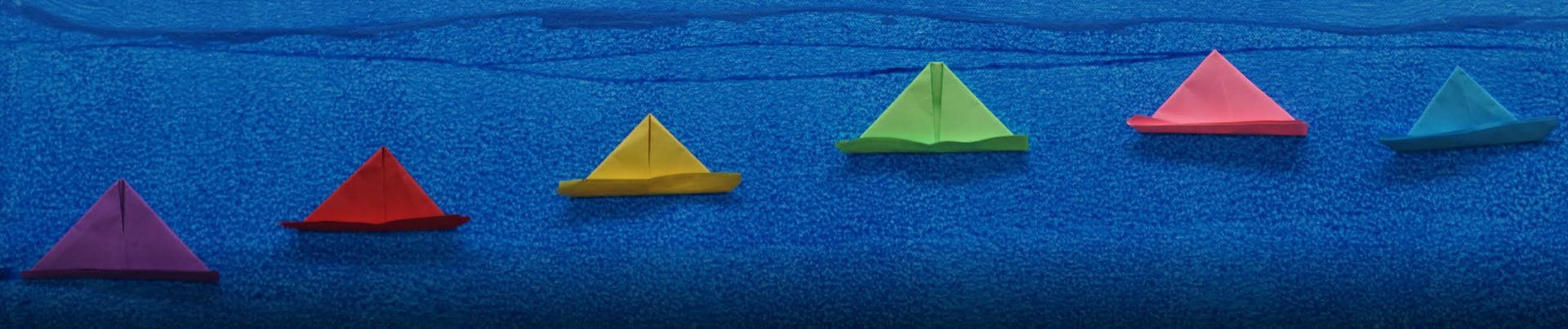 Artwor with blue background and paper boats