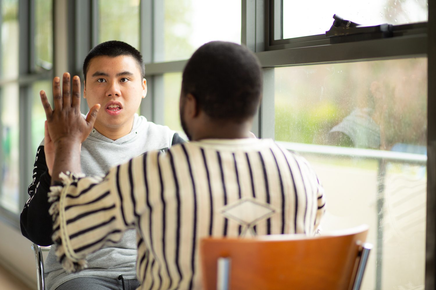 Client highfiving support worker