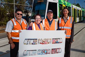 Two Yarra Trams staff, Able client Cathy Staughton and another artist standing in front of a Yarra Trams tram.