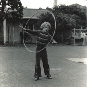 Black and White image of boy with a hula hoop