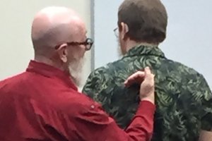 Able Australia interpreter Dennis Whitcombe using tactile sign on Able client Jasper's back.