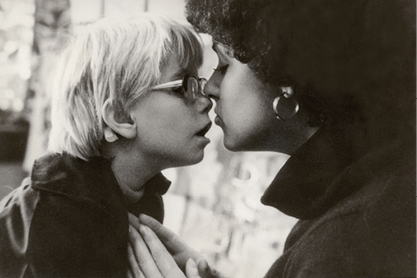 Black and White photo child and adult woman touching noses